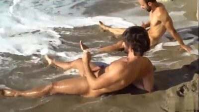 Two gay friends stroking at the beach all gay porn video